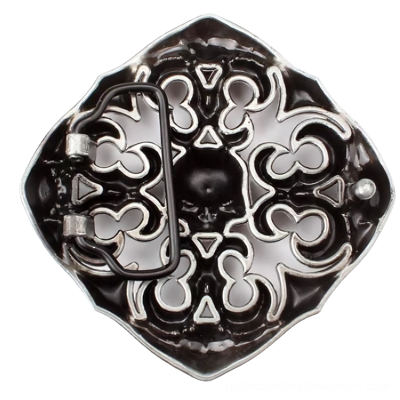 Close-up detail of vintage silver skull buckle from above, displaying intricate carving, fastening mechanism, and antique finish of the gothic rock accessory
