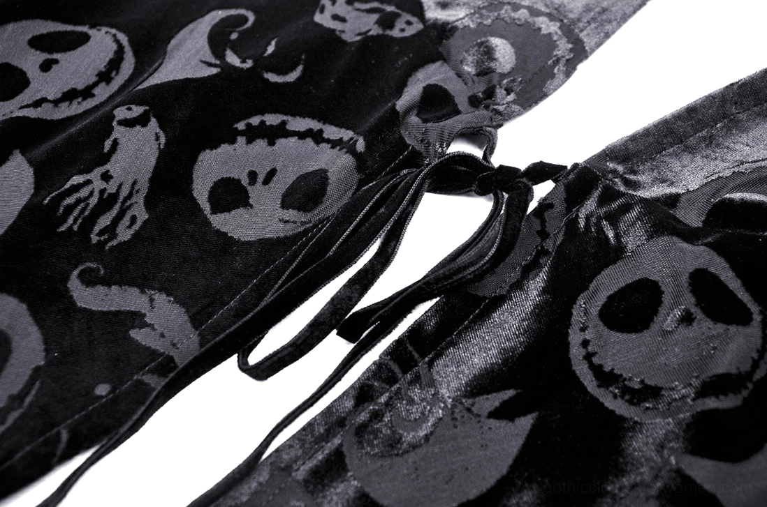 Velvet cape drawstring detail close-up, skull and ghost print embossed pattern, smooth velvet fabric texture, tying rope closure