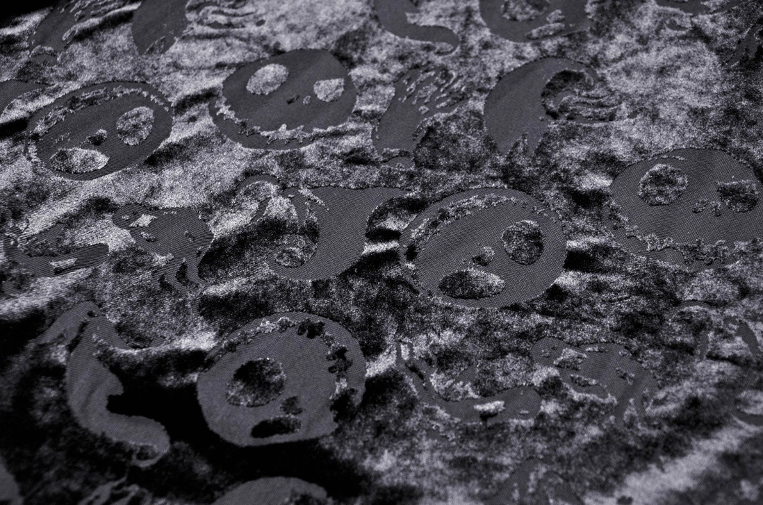 Skull print velvet cape side view detail, embossed pattern quality, hooded design construction, gothic aesthetic
