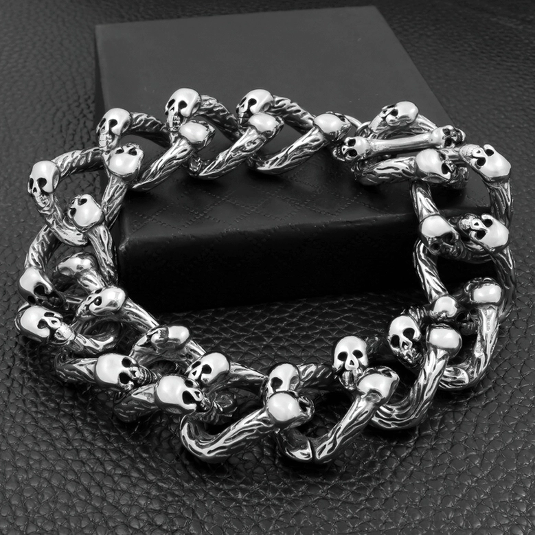 Gothic double-row skull bracelet angled view on black leather surface with detailed skull accent engravings