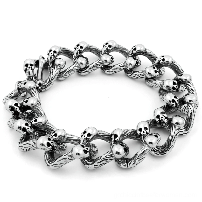 Memento mori skull chain bracelet with double-row curb links and embedded skeleton details, antique silver finish displayed flat lay