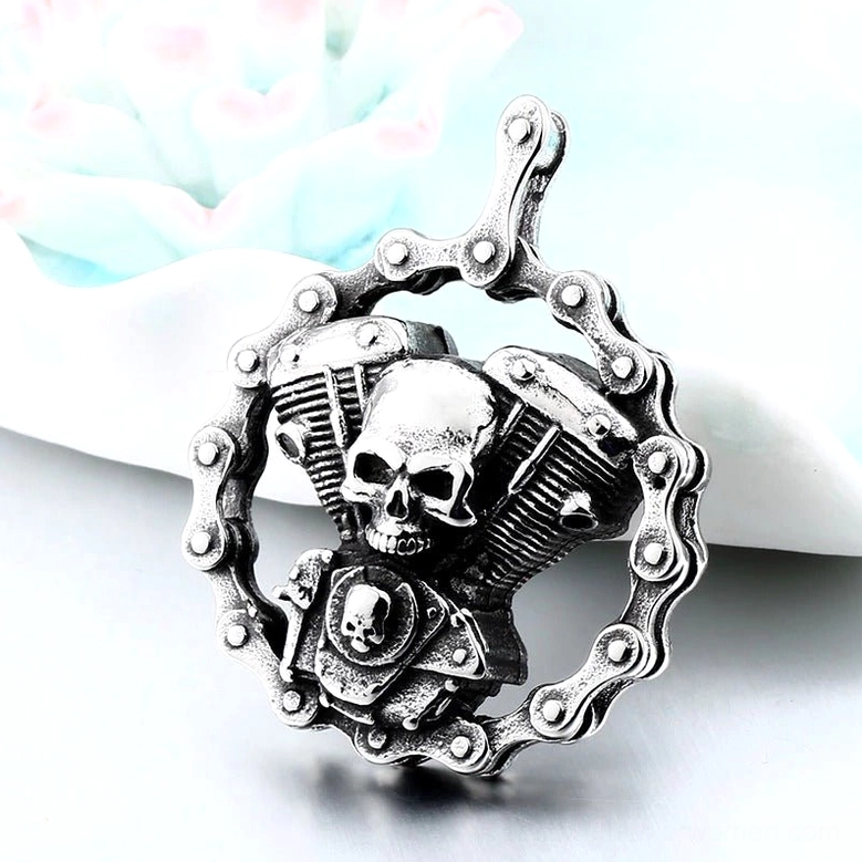Detailed front view of skull engine gothic pendant - twin engine motorcycle design with dual skull details and vintage silver patina