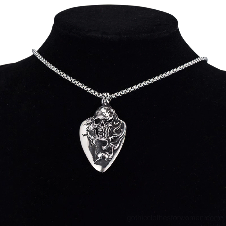 Unisex gothic skull pendant necklace worn on black velvet jewelry stand mannequin, displaying polished silver metal guitar pick design with centered skull motif
