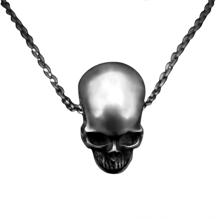 Rear view of antique silver skull pendant revealing intricate back carving and polished finish on gothic necklace