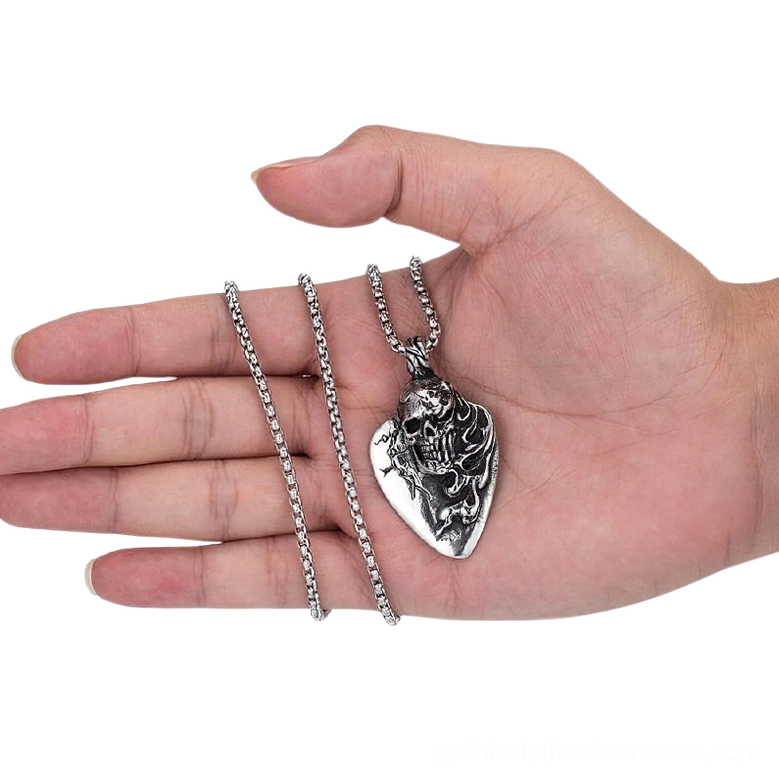 Overhead view of skull guitar pick pendant with two interchangeable necklace chain options on human palm, showing bead chain and rolo chain alternatives