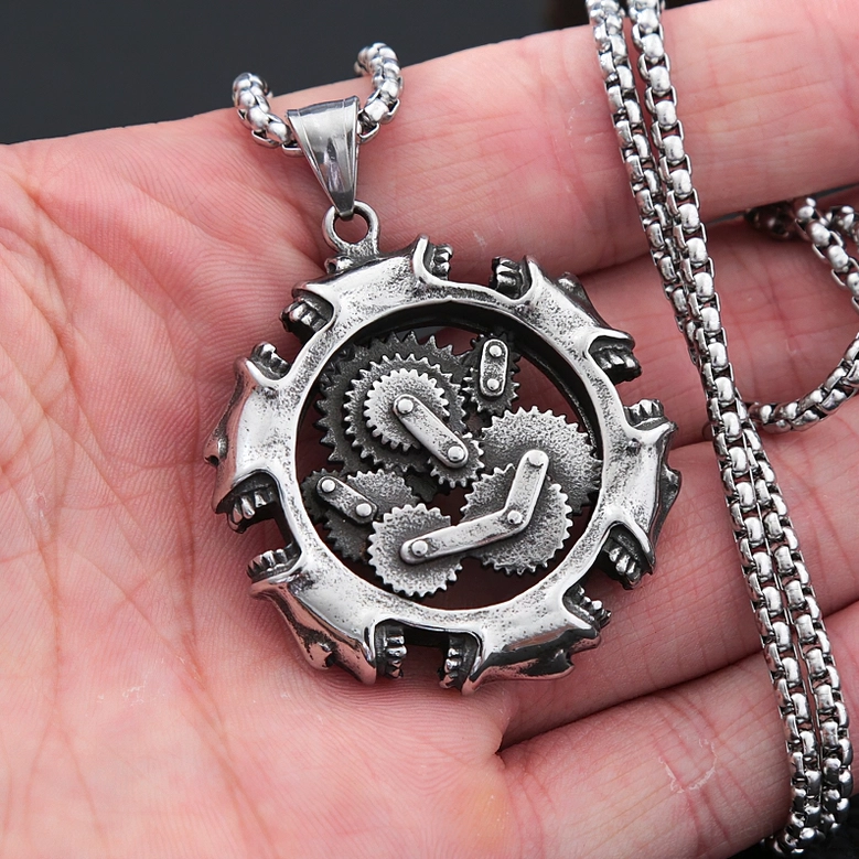 Steampunk mechanical skull pendant worn on hand showing chain length and scale reference for sizing