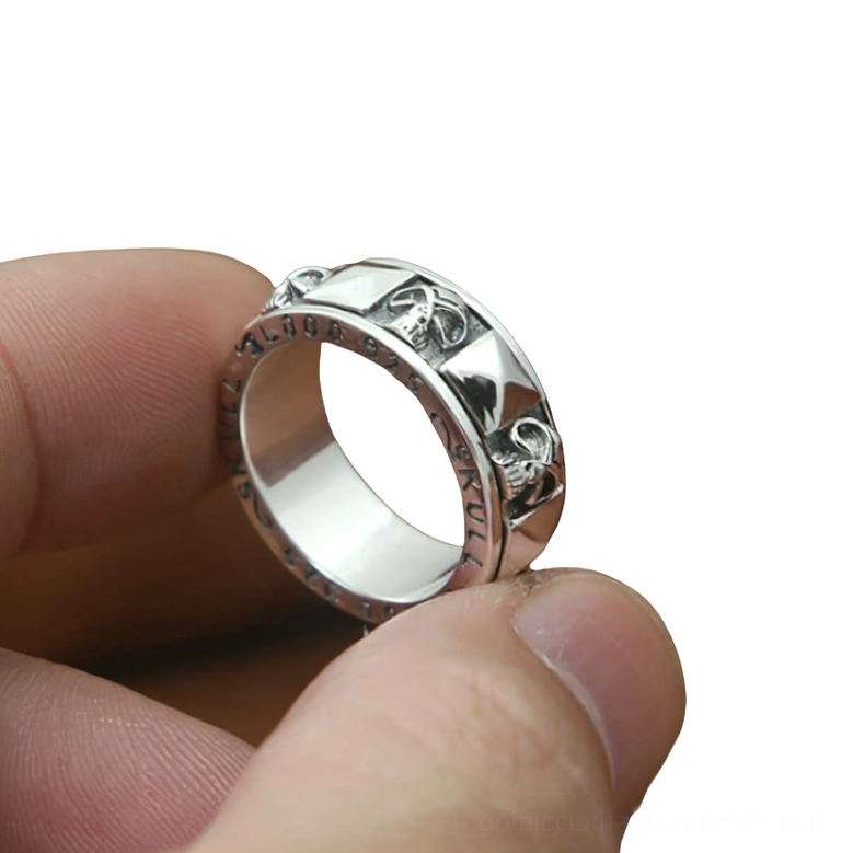 Rotatable skull ring side close-up on human finger showing vintage silver tone and detailed skull carving