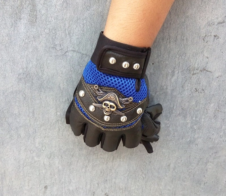 Product hero shot of skull rivet fingerless gloves featuring pirate skull badge and industrial metal rivets