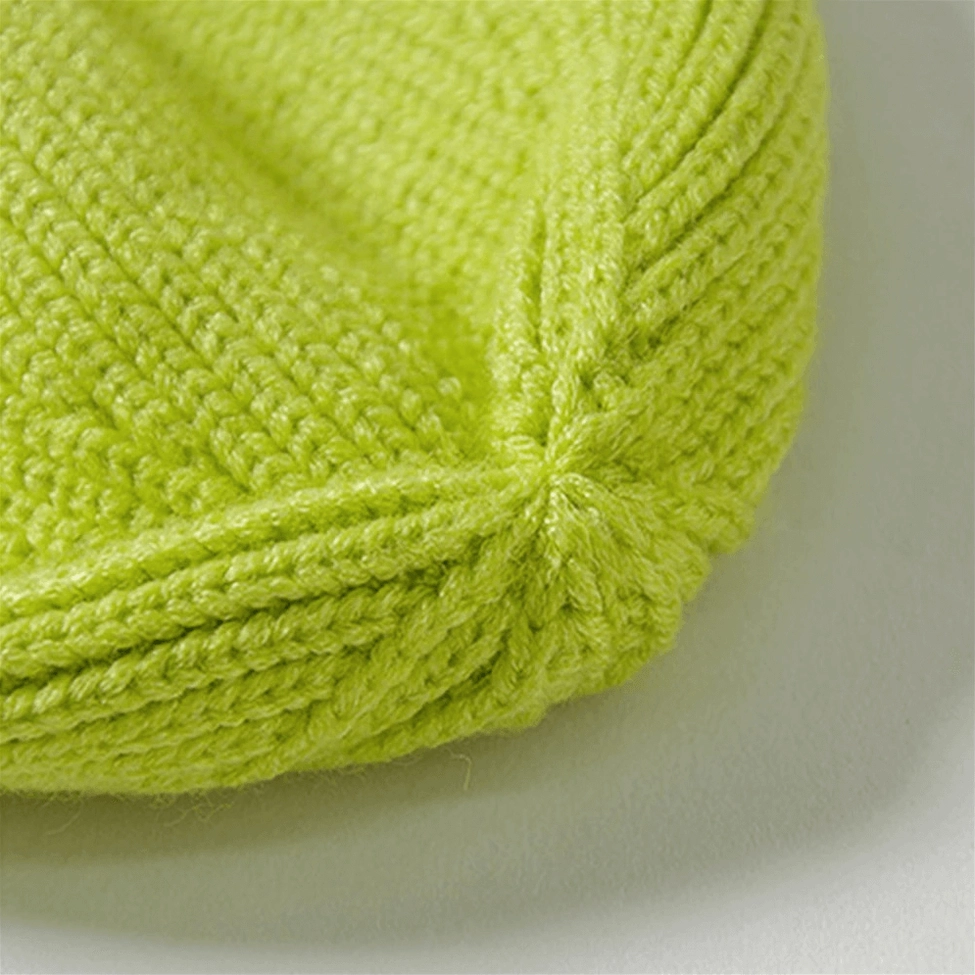 Smiley face embroidered knit beanie profile view showing fit and embroidered smiley placement, dark aesthetic winter hat