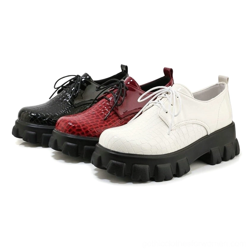 All three colorways of snake-pattern platform pumps displayed side-by-side: black, burgundy, and white on clean white background
