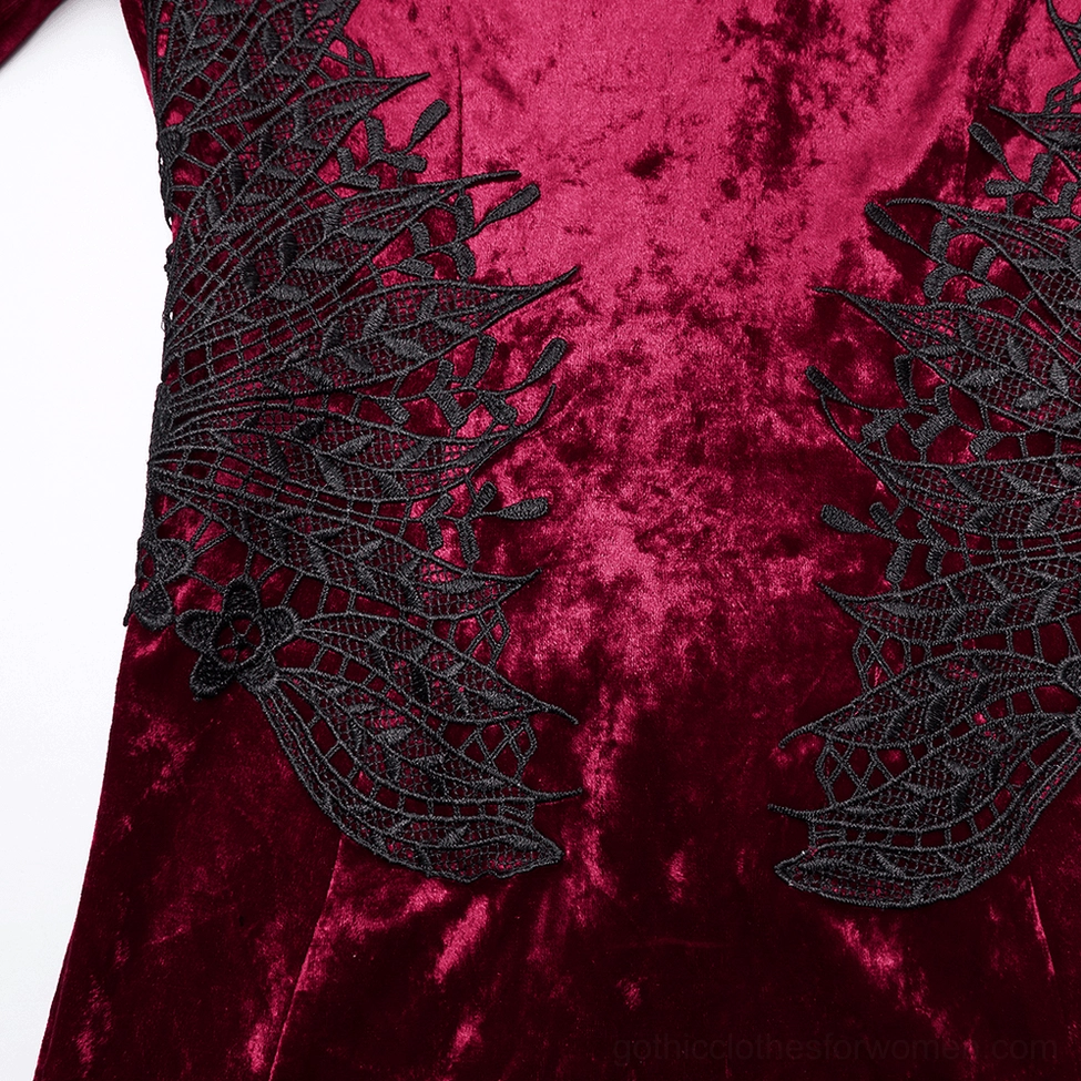 Close-up of spiderweb lace applique waist detail on wine red crushed velvet with intricate embroidered lace pattern