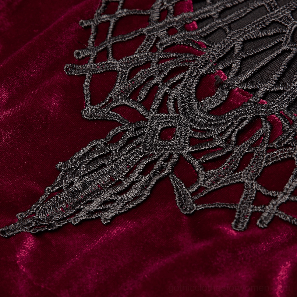 Close-up detail of black spiderweb lace collar on burgundy wine red velvet gothic dress showing intricate lacework