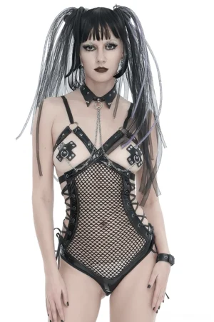 Gothic woman wearing black spiked choker with cross-shaped riveted nipple covers and silver chain, front full-body view on white background