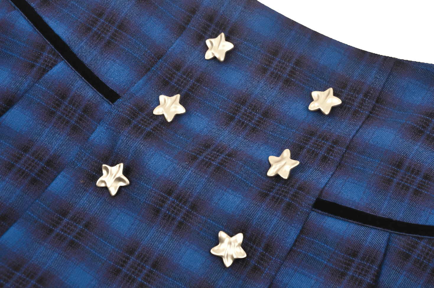 Metallic star button and blue black tartan fabric detail - product embellishment close-up