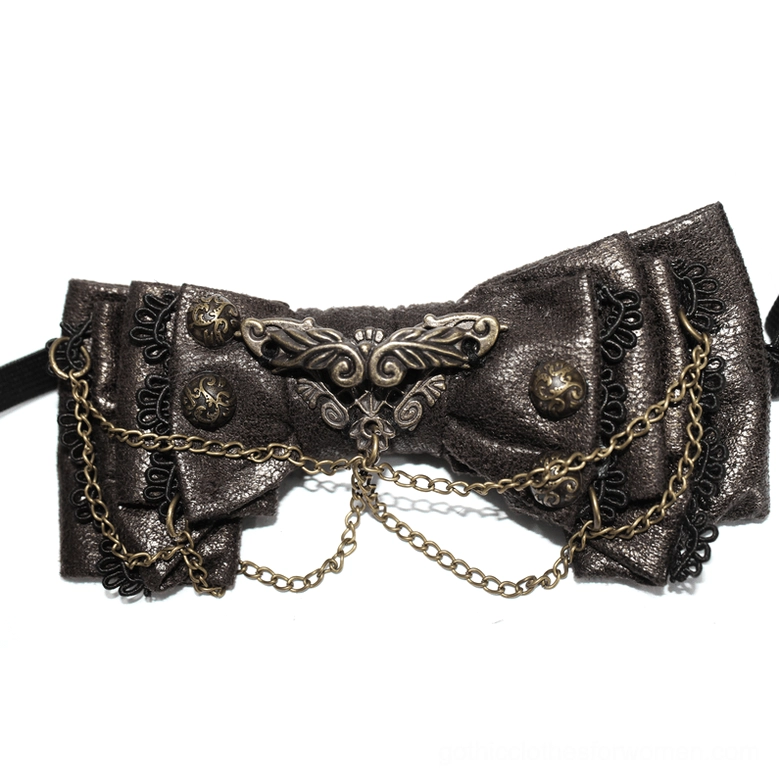 Extreme close-up of steampunk bow tie ornate metal filigree, brass chains, and studded leather detailing