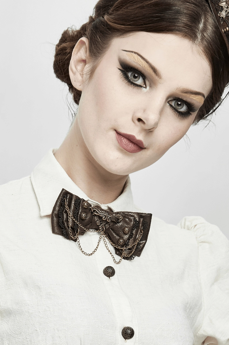 Front close-up of steampunk brown bow tie choker worn on model showing ornate metal details and styling on white collared blouse