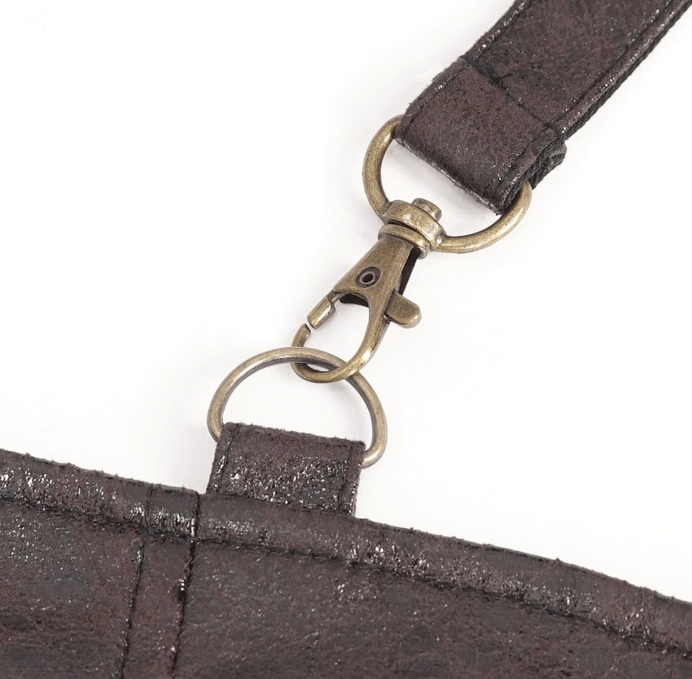 Close-up of steampunk harness antique brass metal clasp, split metal ring, and distressed leather strap connection hardware detail