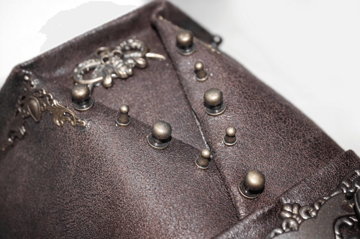 Steampunk hat worn perspective showing how skull ornament and metal rivets align on dark brown leather top hat silhouette