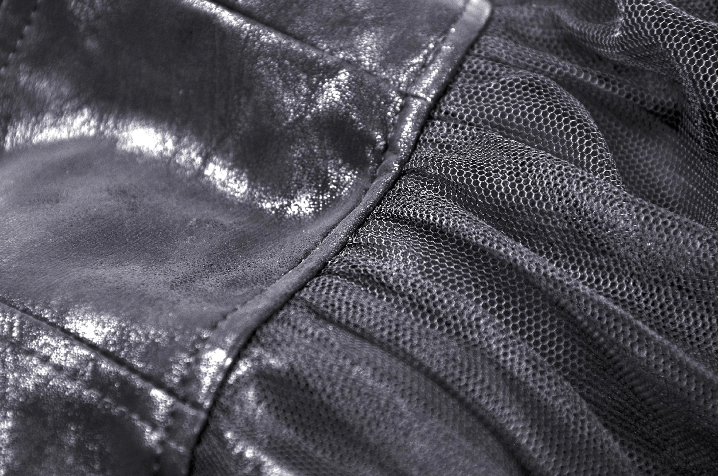 Fabric texture close-up of black steampunk gothic skirt showing distressed PU leather and gathered tulle mesh layers