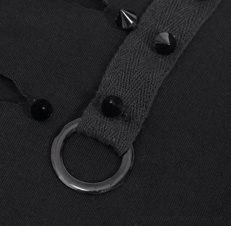 Close-up of gothic tank top strap detail featuring cone spike studs, metal D-ring hardware, and woven fabric construction
