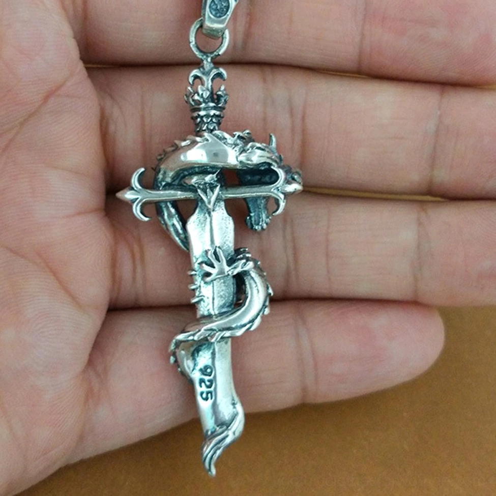 925 sterling silver mark on dragon sword pendant held in palm - authentic fine jewelry certification