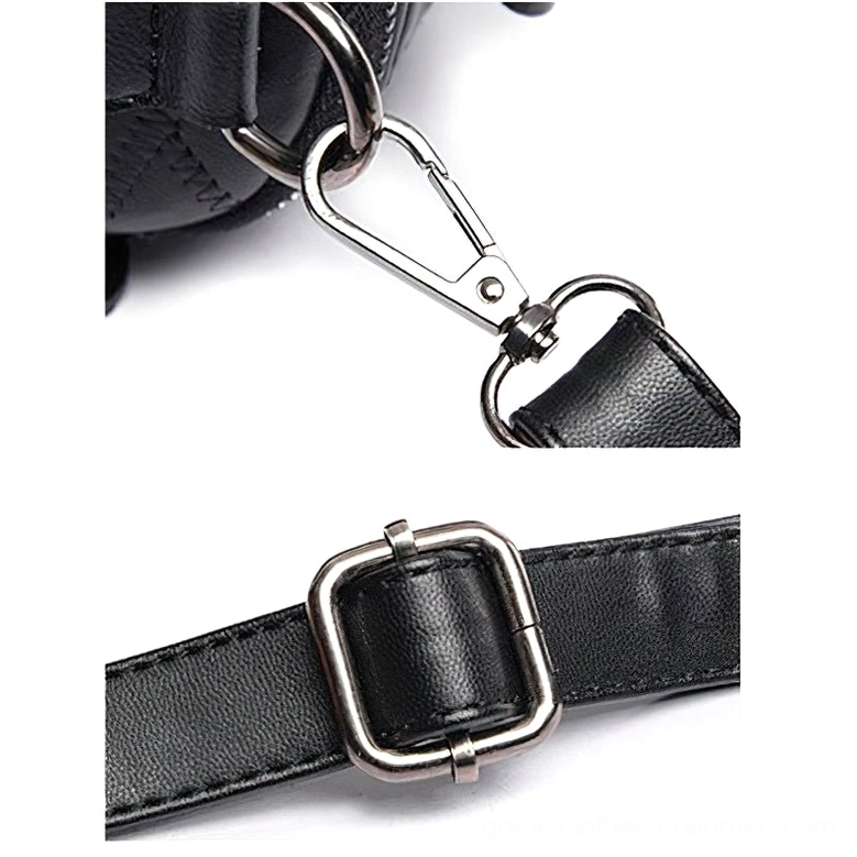 Close-up macro view of black leather crossbody bag hardware including metal buckle, snap hook, and adjustable leather strap attachment