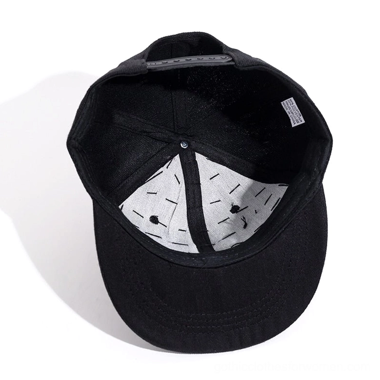 Interior detail of spiked baseball cap showing white lining and adjustable snap closure mechanism