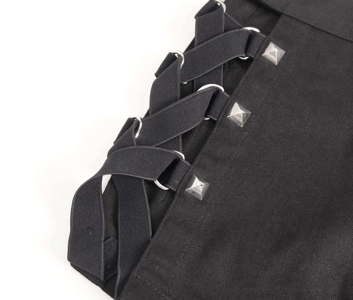 Black studded mesh garters detail shot showing welded metal hardware and attachment points