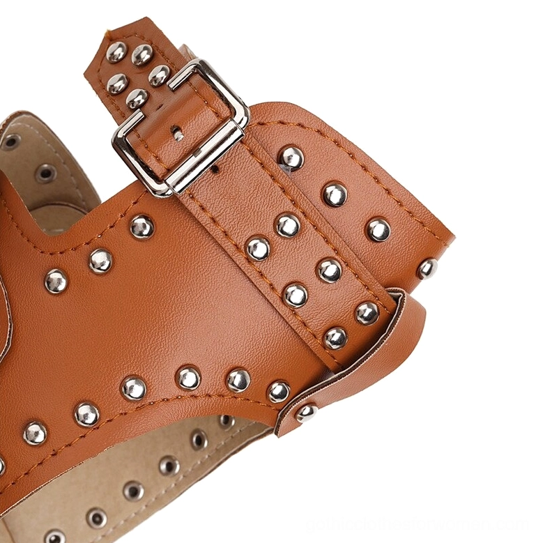 Detailed close-up of adjustable silver metal buckle closure with multiple decorative studs on brown leather strap