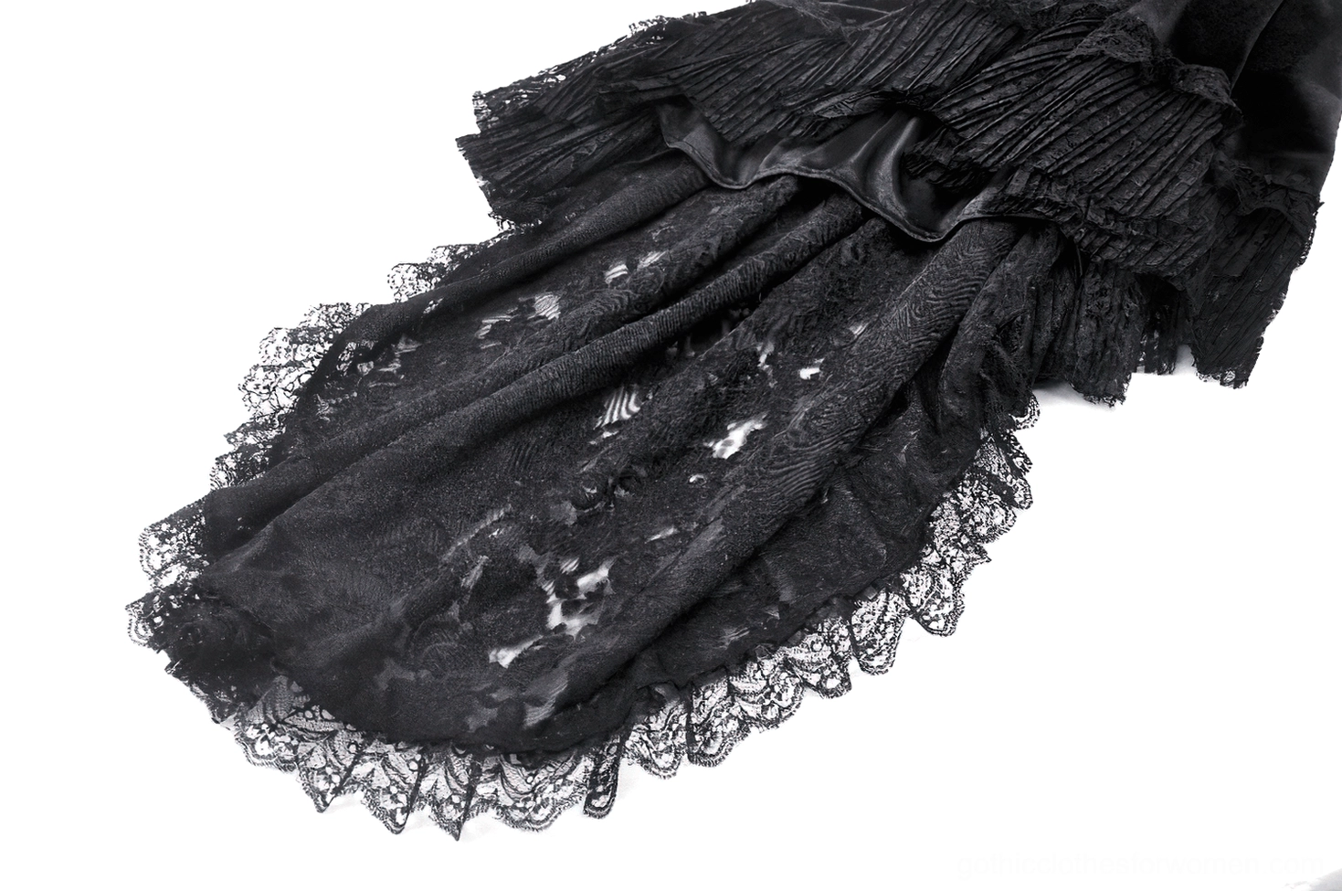 Close-up detail of swallowtail gothic dress tail hem showing sheer black lace, multi-layered ruffled trim, and dramatic high-low hemline design