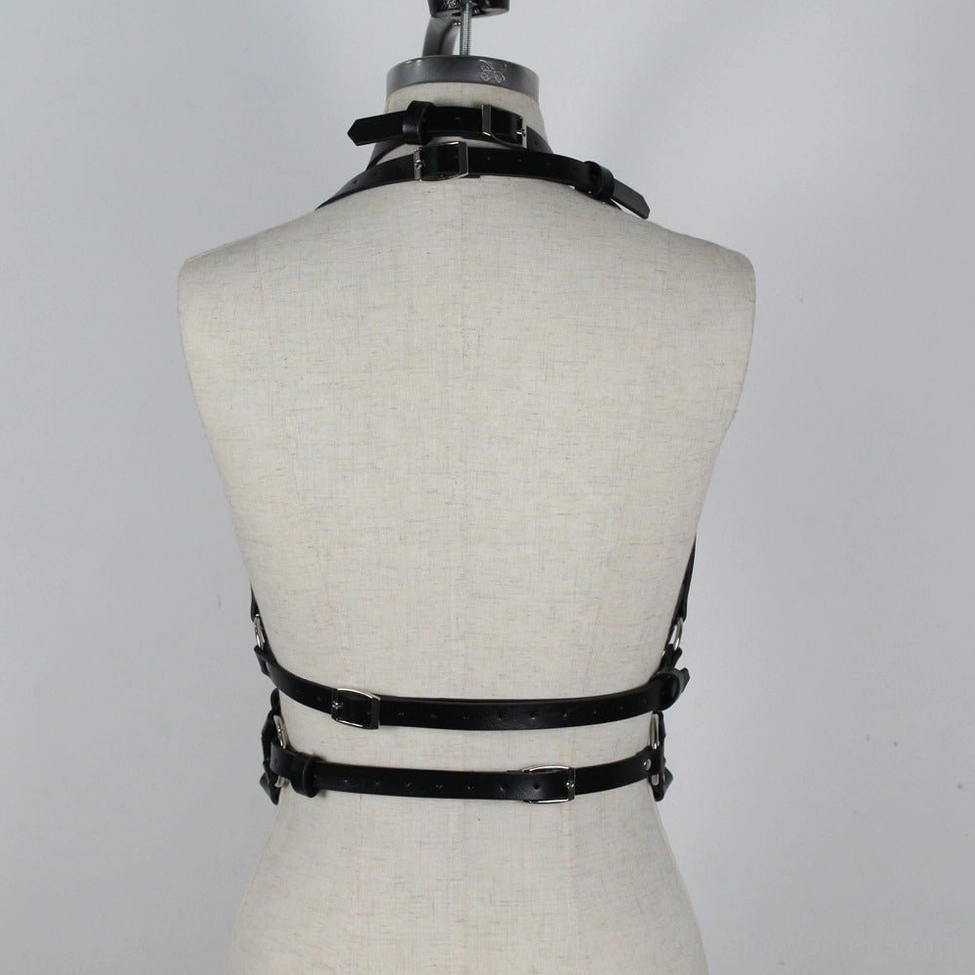 Synthetic leather harness showing multi-point strap design and metal hardware perfect for BDSM and gothic fashion communities