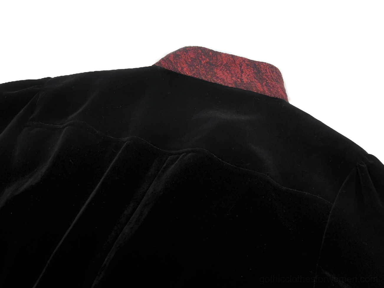 Back collar detail of black velvet tailcoat showing wine red inner collar and premium velvet finish