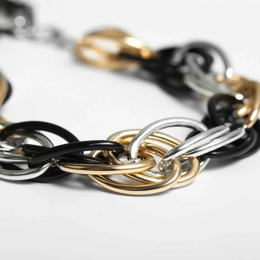 Side close-up of chunky twisted chain with mixed black gold silver links, gothic metal necklace texture