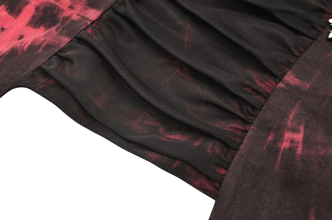 Macro shot of red and black tie-dye fabric texture, revealing gathered stretch weave and color gradient details