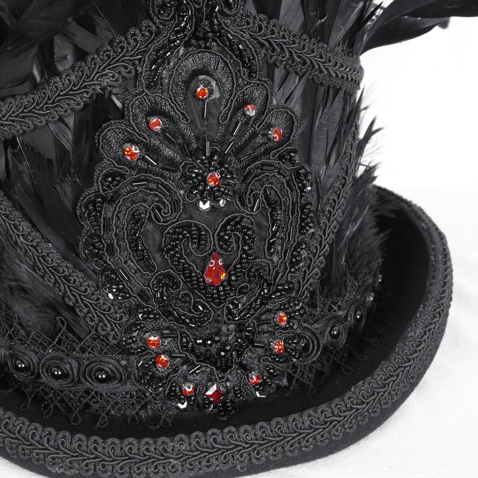 Close-up detail of black feathered top hat front decoration with intricate lace and red gemstones