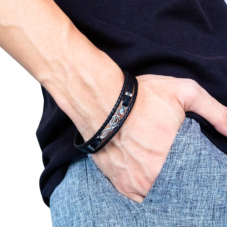 Men's treble clef leather bracelet worn on wrist side close-up view with casual dark clothing background