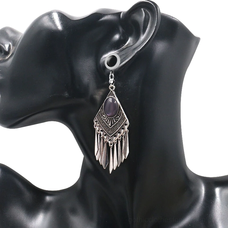 Tribal gothic tunnel earring worn on mannequin - dark aesthetic jewelry styling with carved details and gemstone focus