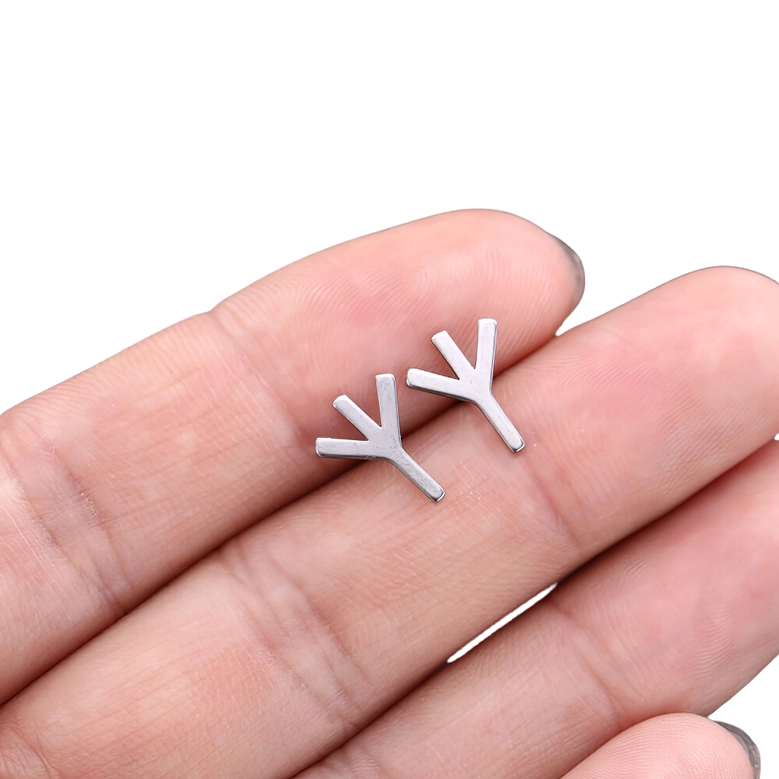 Trident gothic rune stud earring in fingertips, silver-toned minimalist hollow design with mystical aesthetic