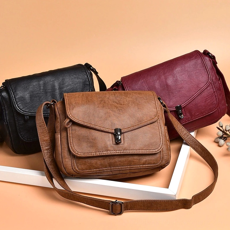Twist-lock closure mechanism of gothic leather handbag, vintage crossbody design