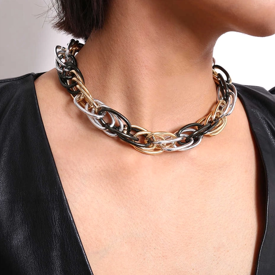 Tri-tone twisted chain necklace worn as gothic choker on model, close-up neck view of statement piece