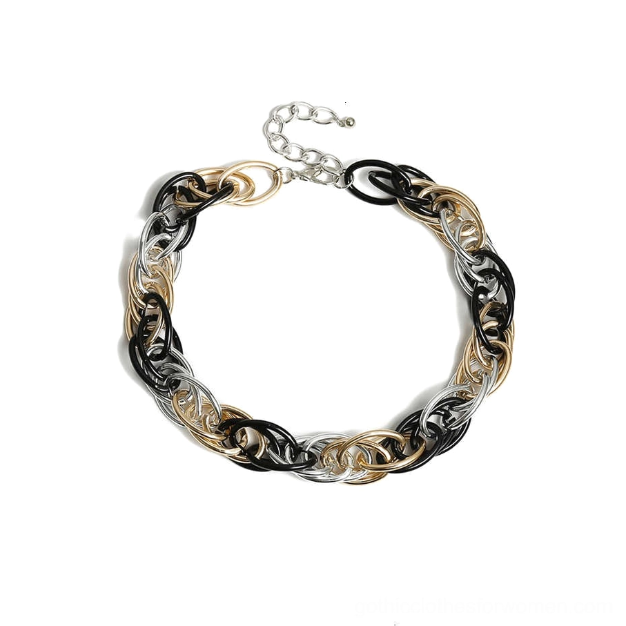 Close-up overhead view of thick twisted oval chain links in mixed metal tones, gothic necklace detail