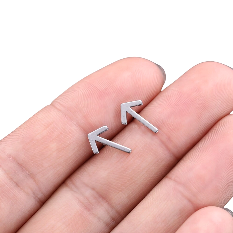 Unisex gothic rune stud earrings detail shot, silver stainless steel studs with hollow minimalist rune symbols