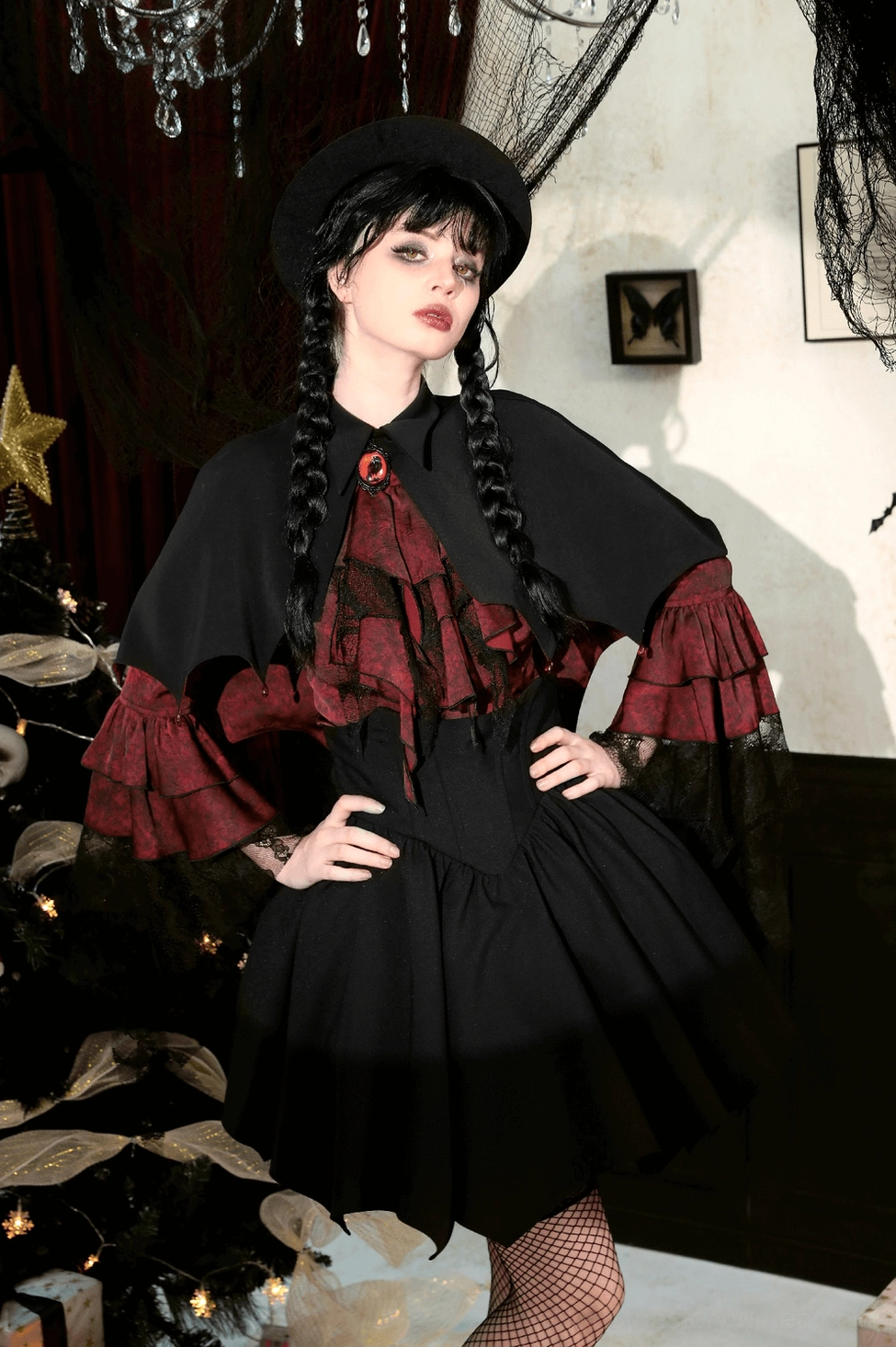 Flat lay shot of vampire cape highlighting the contrast between black outer fabric and striking blood-red inner lining, revealing design at hem