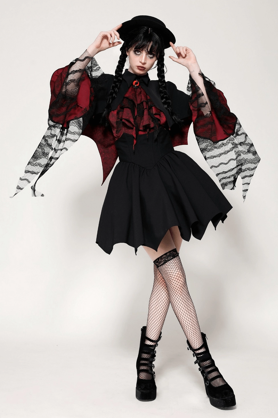 Studio shot of vampire cape displaying the architectural high collar design, black matte exterior finish, and structured bat-wing hem points