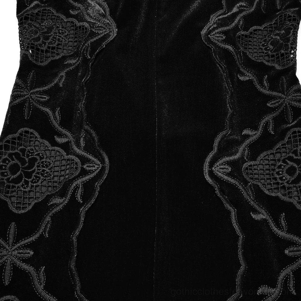 Close-up texture detail of black velvet fabric and delicate embroidered lace trim showing craftsmanship and material quality