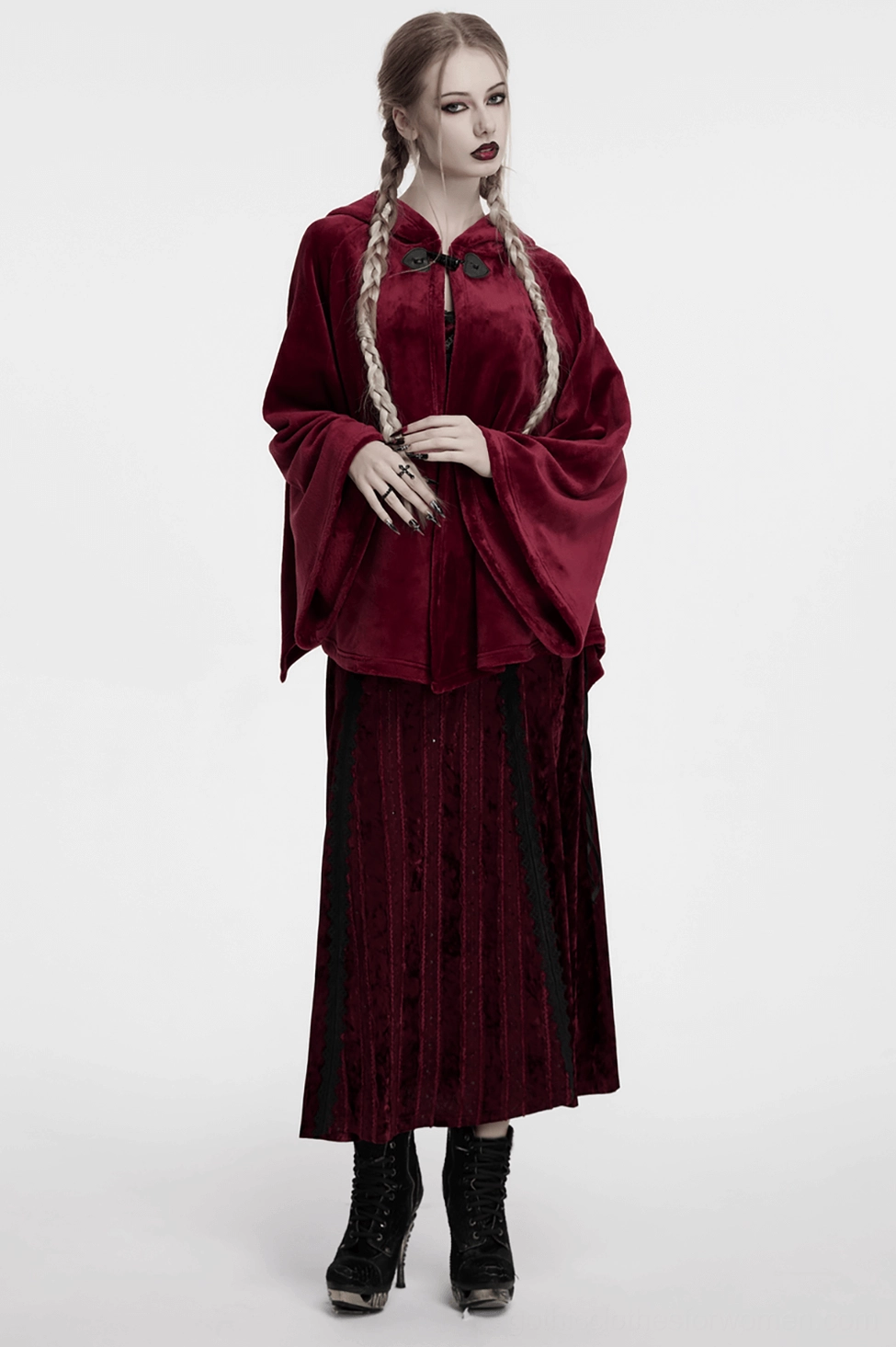 Detail shot of wine red velvet fabric texture and burgundy color richness on gothic hooded cape