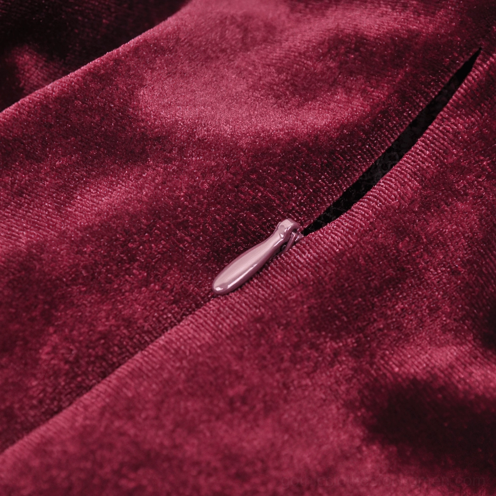 Burgundy velvet fabric texture and concealed back zipper of gothic mini dress