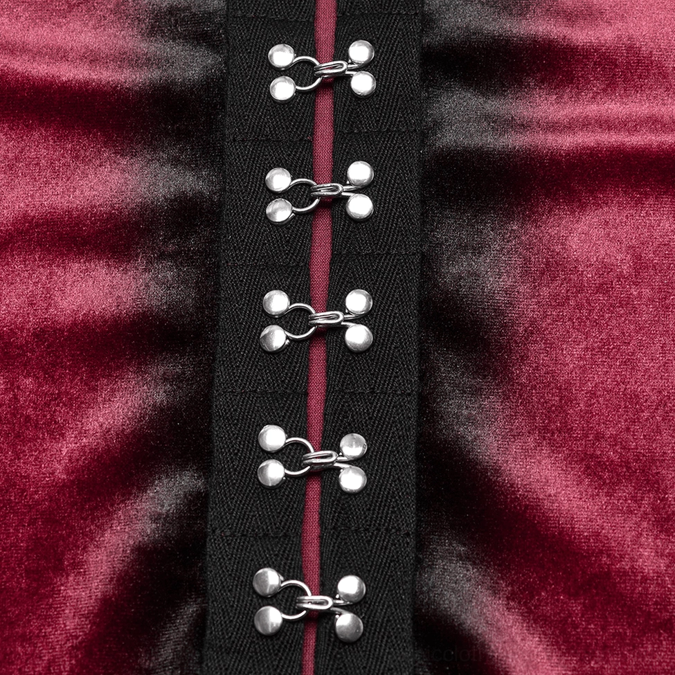 Extreme close-up detail of burgundy velvet gothic top fabric showing shiny velvet texture, black trim tape, and silver metal clasp fasteners
