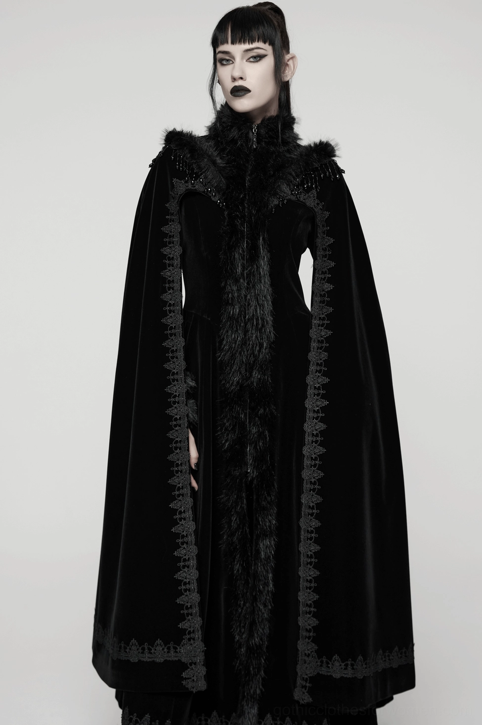Full-length black velvet gothic cloak coat on model showcasing dramatic floor-length hem