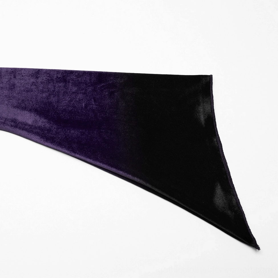 Close-up texture detail of purple to black gradient velvet fabric with pointed asymmetric edge